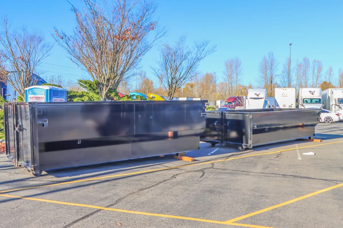 Professional dumpster rental service with roll-off container on residential driveway in Elko